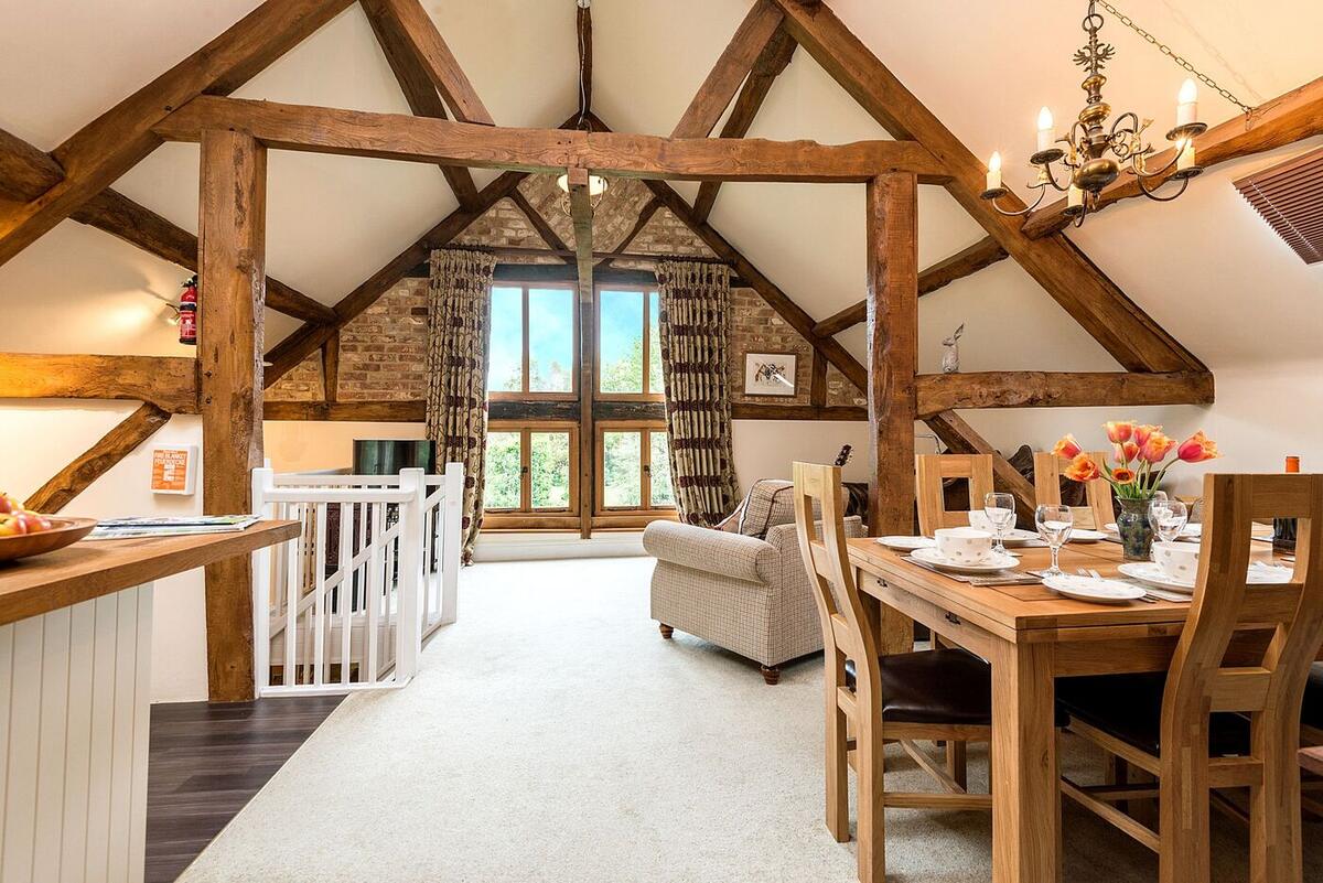 Open-plan living room under huge oak trusses