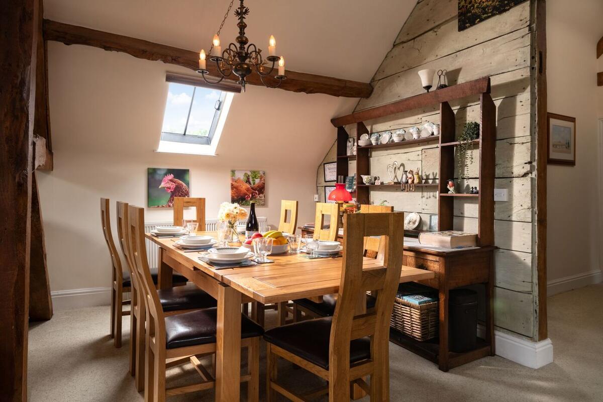 Wooden dining table under a beamed ceiling