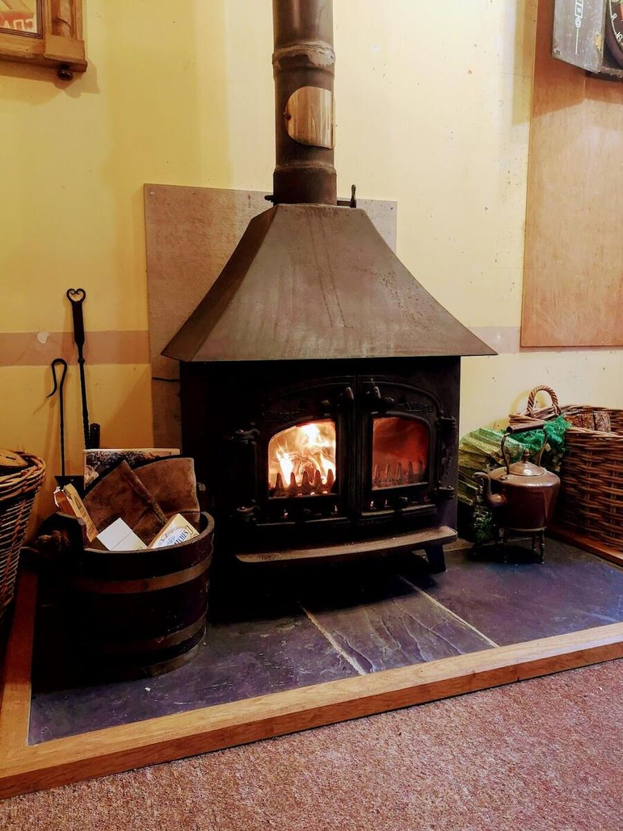 Log burner glowing in a stove corner