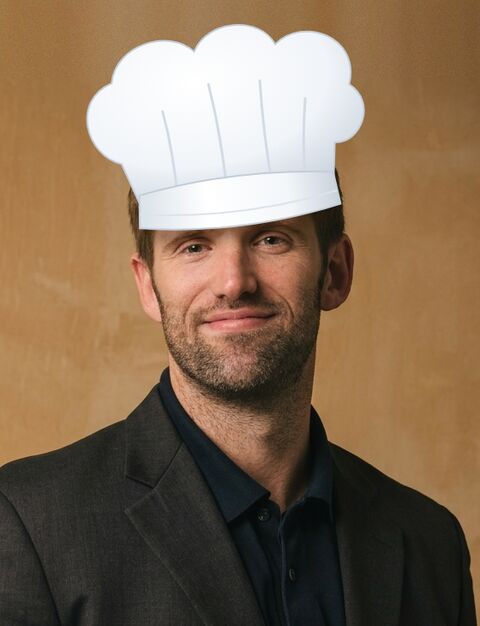 David wearing a tall white chef's hat