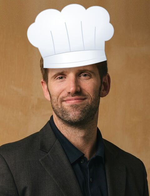 David wearing a tall white chef's hat