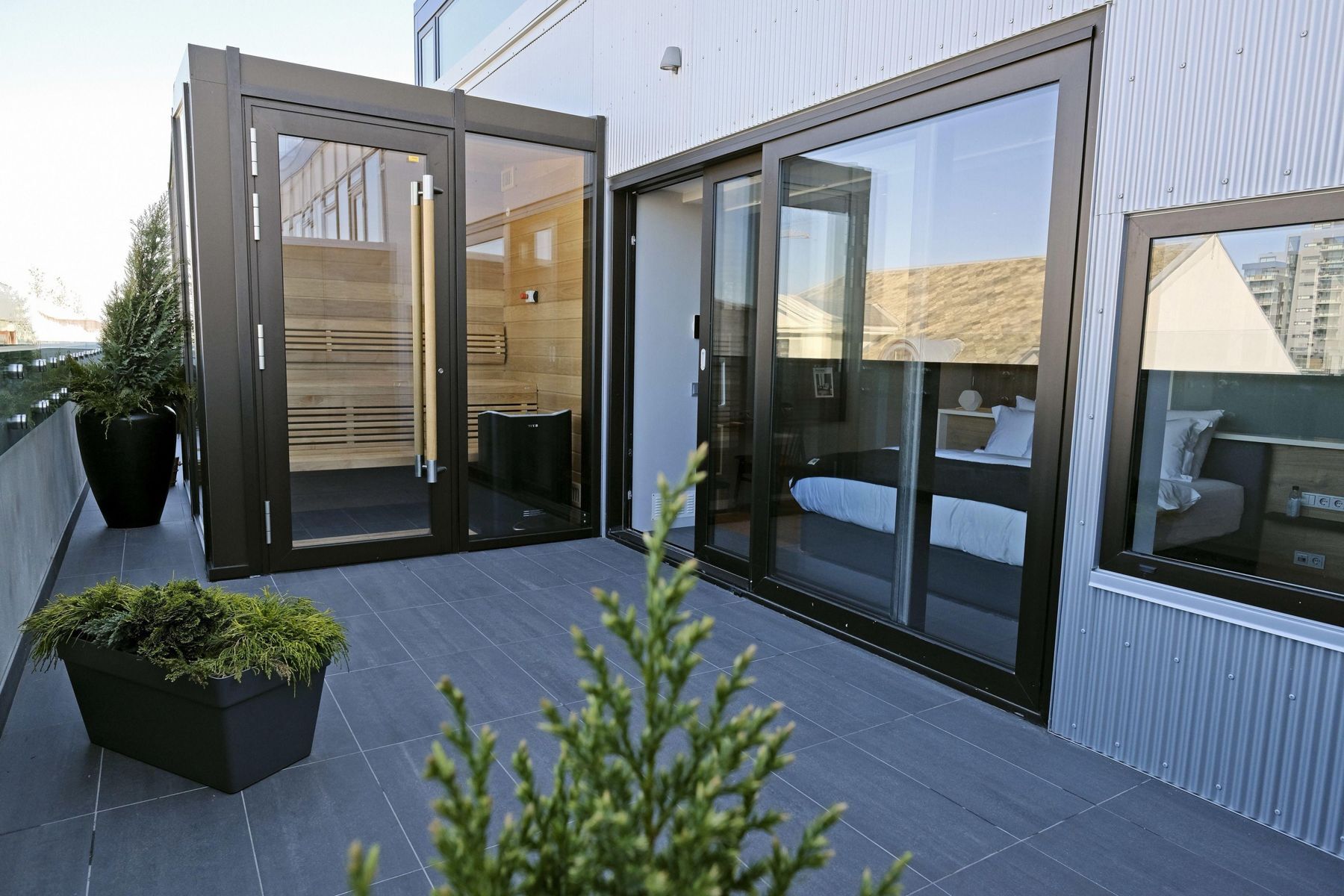 Glass-fronted sauna on a private balcony next to the bedroom
