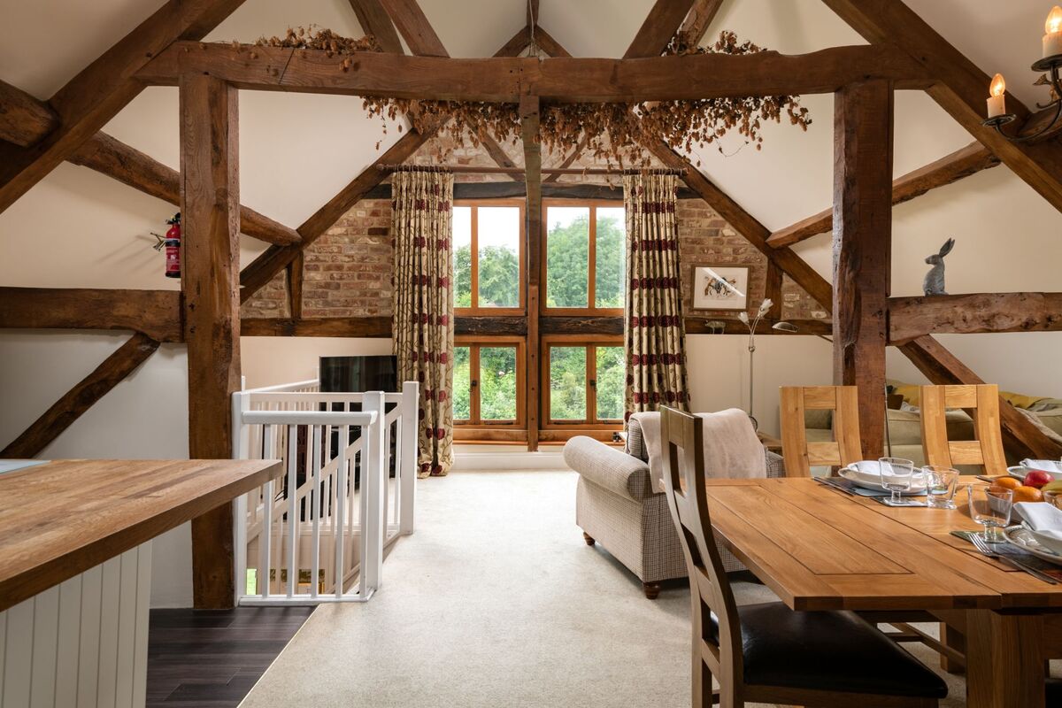Oak-beamed room with dried hops along the rafters