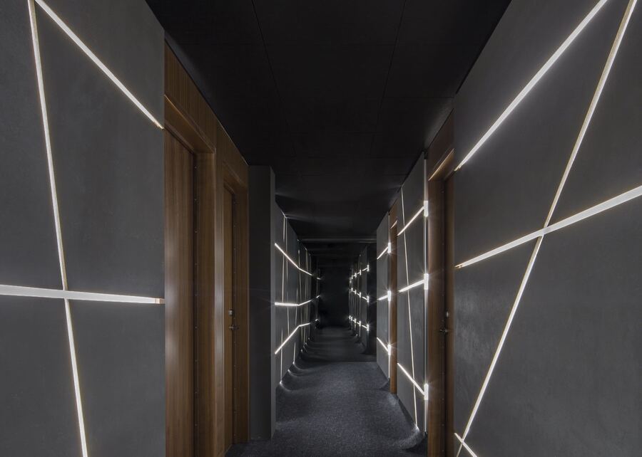 Dark corridor with diagonal light strips
