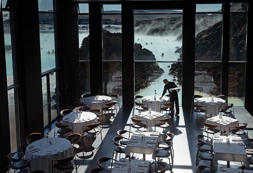 Lava Restaurant: tables laid in a tall glass hall looking straight out over the steaming Blue Lagoon