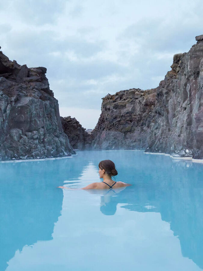 Swimming in a milky blue lagoon between lava walls