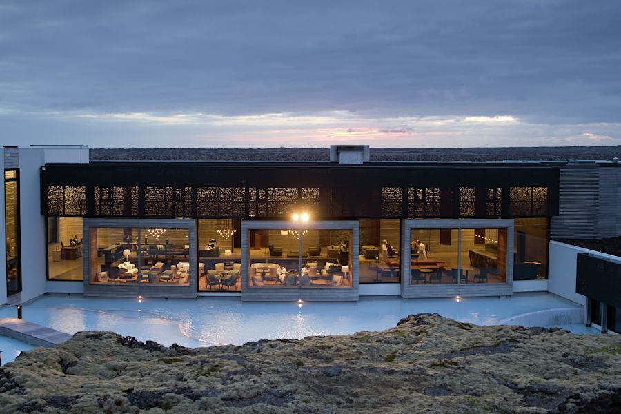 The hotel lit up at dusk above the lagoon