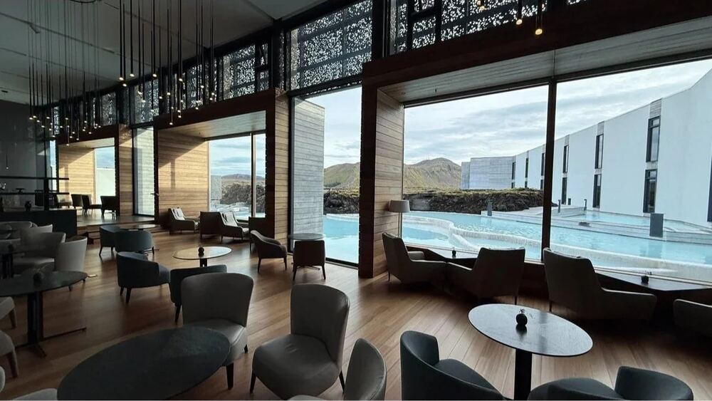 Spa Restaurant's lounge with armchairs and tall windows over the lagoon